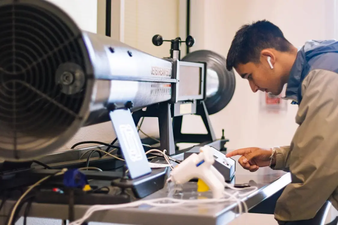 NDT technician operating inspection equipment during a non-destructive testing procedure